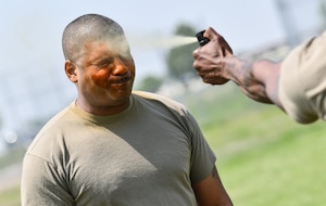 A sergeant gets sprayed with pepper spray