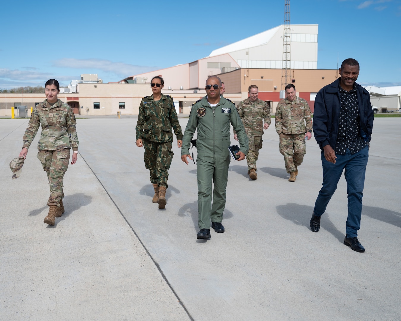 Leadership from Cabo Verde and a team of airmen from the 157th Air Refueling Wing walk to a KC-46 Pegasus prior to an orientation flight May 9, 2024, at Pease Air National Guard Base in Newington, N.H.
