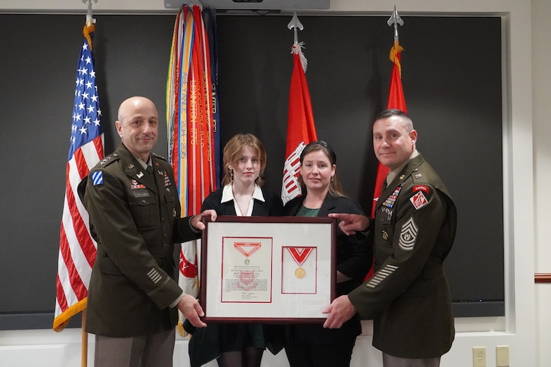 Lt. Gen. Scott Spellmon, far left, 55th Chief of Engineers and commanding general of the U.S. Army Corps of Engineers, and USACE Command Sgt. Maj. Douglas Galick, far right, pose with Katie Celiz, Sgt. 1st Class Christopher A. Celiz's wife, and his daughter Shannon.