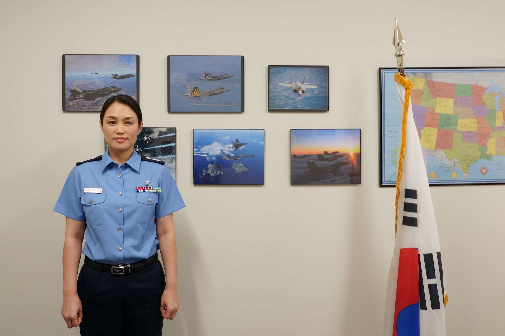 Female South Korean Air Force officer stands in front of her nation's flag. (Contributed photo).
