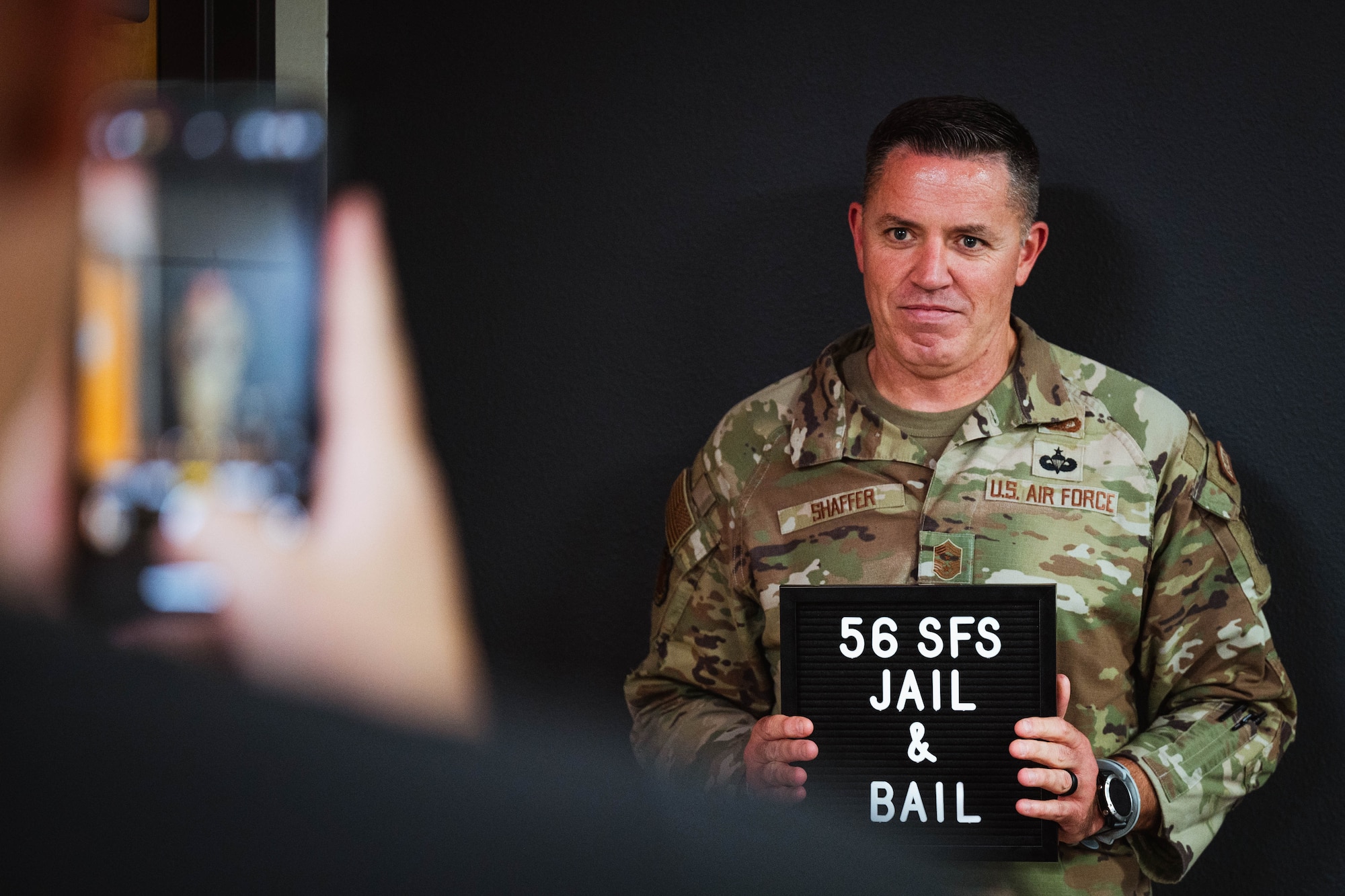 U.S. Air Force Chief Master Sergeant Jason Shaffer, 56th Fighter Wing command chief, participates during a jail and bail event for the 2024 Police Week.