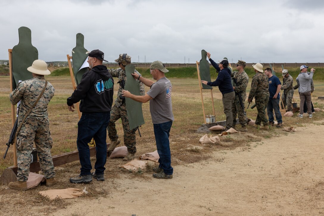 U.S. Marines with Weapons and Field Training Battalion, Recruit Training Regiment, review shot groupings with members of Vistage following a live-fire range at Marine Corps Base Camp Pendleton, California, May 15, 2024. Vistage members observed recruit training in order to gain a better understanding about the transformation from recruits to United States Marines. They also received classes and briefs about benefits provided to service members serving in the United States armed forces. (U.S. Marine Corps photo by Lance Cpl. Jacob B. Hutchinson)