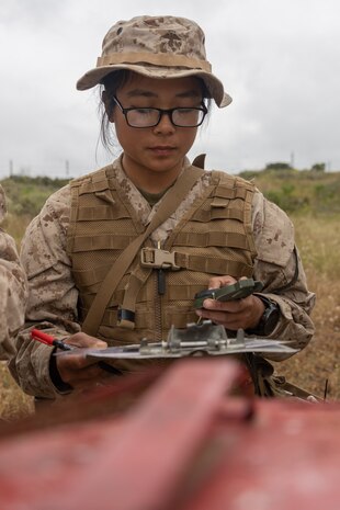 U.S. Marine Corps Recruit Kathleen Nguyen with Lima Company, 3rd Recruit Training Battalion, uses her compass during the land navigation training exercise at Marine Corps Base Camp Pendleton, California, May 16, 2024. Land navigation is part of basic warrior training and is designed to teach recruits how to use a compass and map for navigation. (U.S. Marine Corps photo by Lance Cpl. Janell B. Alvarez)