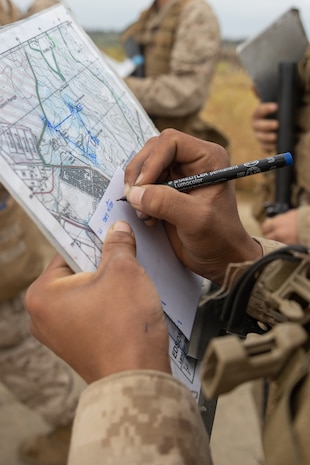 U.S. Marine Corps Recruit Armando Valdez with Lima Company, 3rd Recruit Training Battalion, writes down his pace count during the land navigation training exercise at Marine Corps Base Camp Pendleton, California, May 16, 2024. Land navigation is part of basic warrior training and is designed to teach recruits how to use a compass and map for navigation. (U.S. Marine Corps photo by Lance Cpl. Janell B. Alvarez)