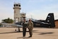 Honduran Air Force Lt. Col. Dulce Maria Vasquez Amador, Soto Cano Air Base Commander, and U.S. Army Col. Paul Witkowski, Army Support Activity Commander, pose for a photo in front of the original control tower back in 1986 at Soto Cano Air Base, Honduras, May 16, 2024. Soto Cano Air Base has become a staple in Central America and a home to the DoD’s Joint Task Force-Bravo and to hundreds of Honduran military members. (U.S. Air Force photo by Capt. Dorothy Sherwood)