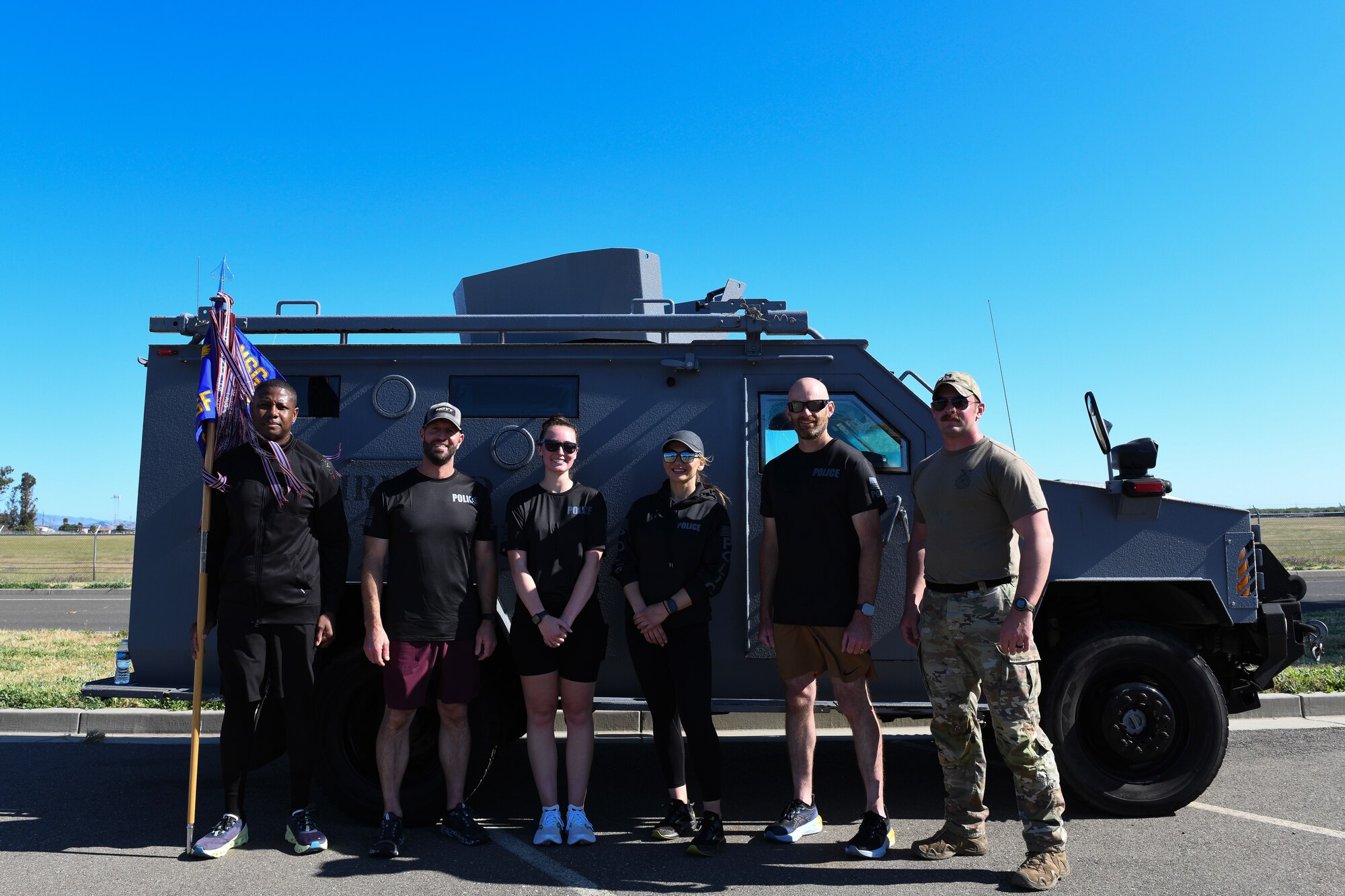 Airmen pose for a group photo after ruck march