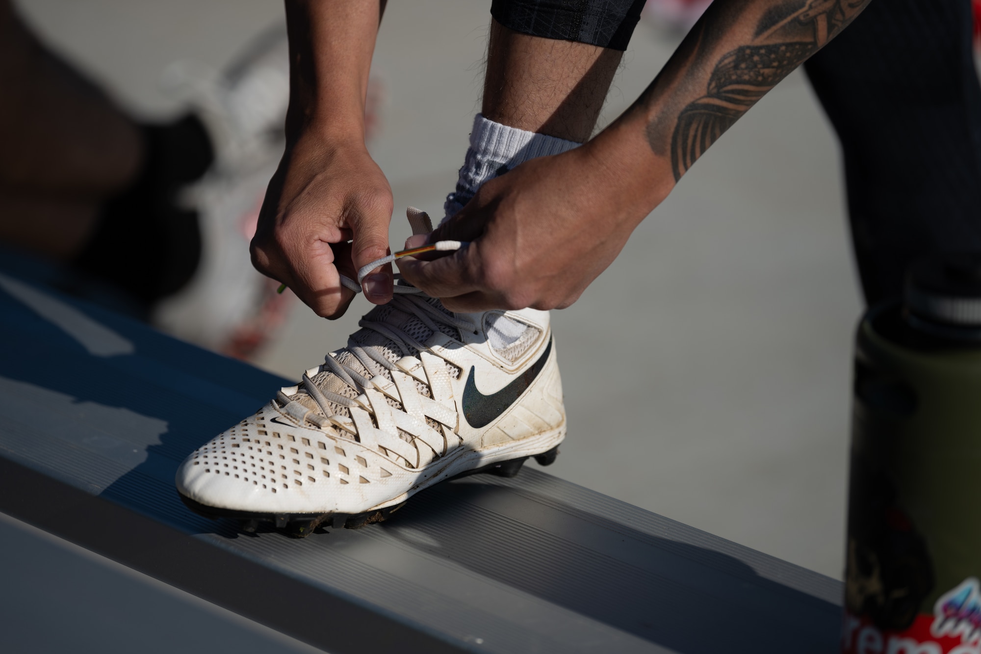 Closeup of hands of a police officer tying his shoes