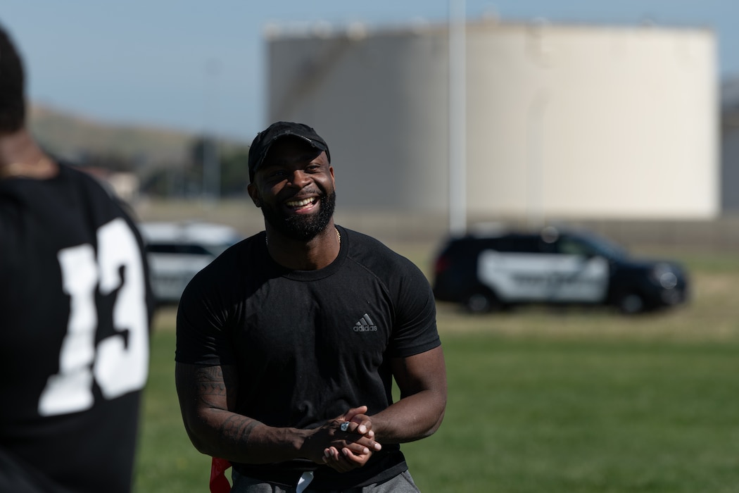 Airman smiling after a successful play during a flag football game