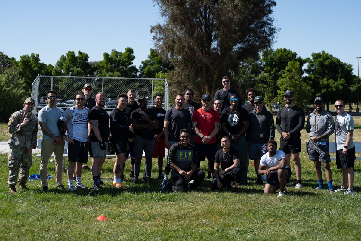 Airmen pose for a group photo after a flag football game