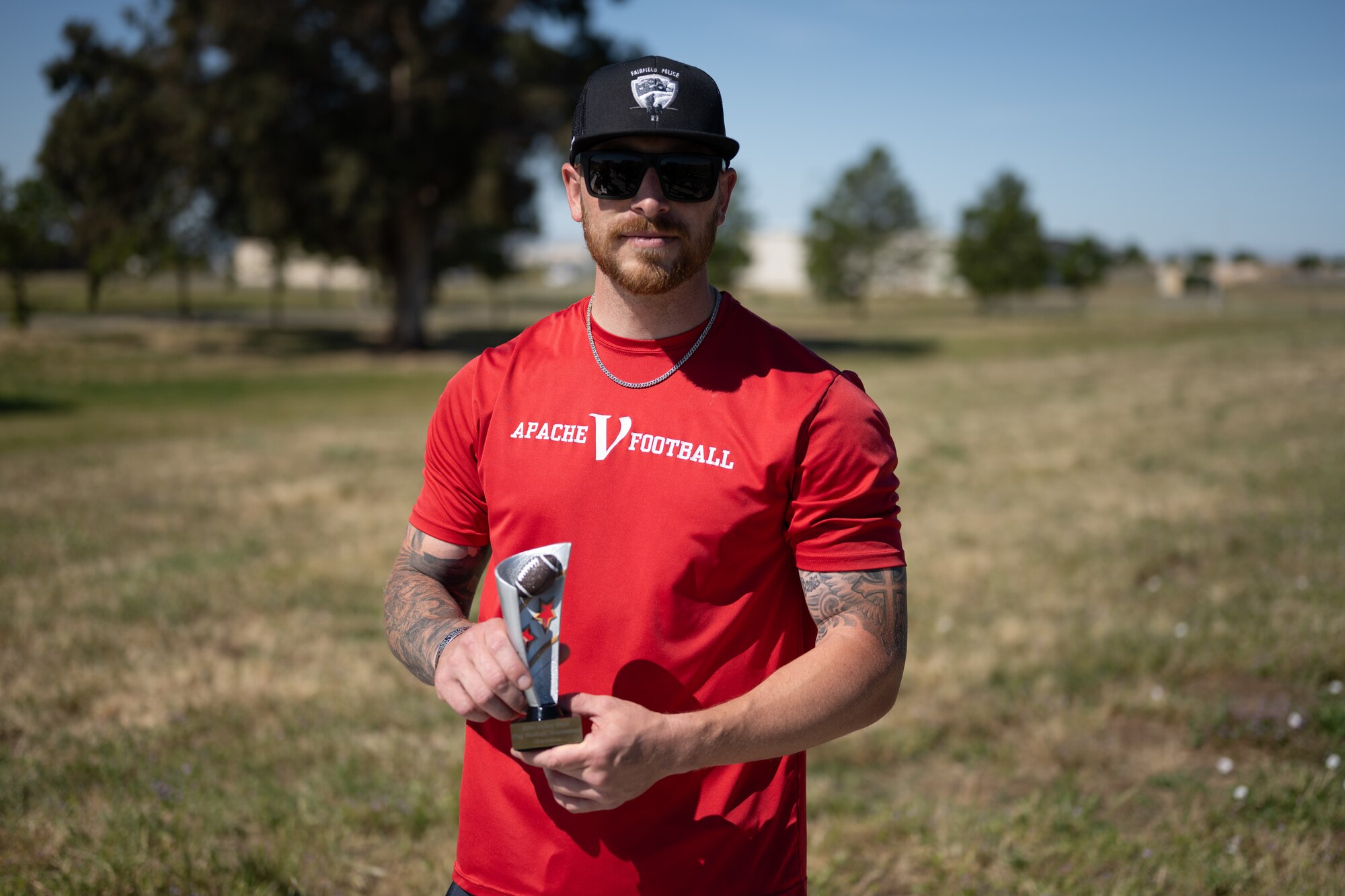 Airman poses for a photo with trophy