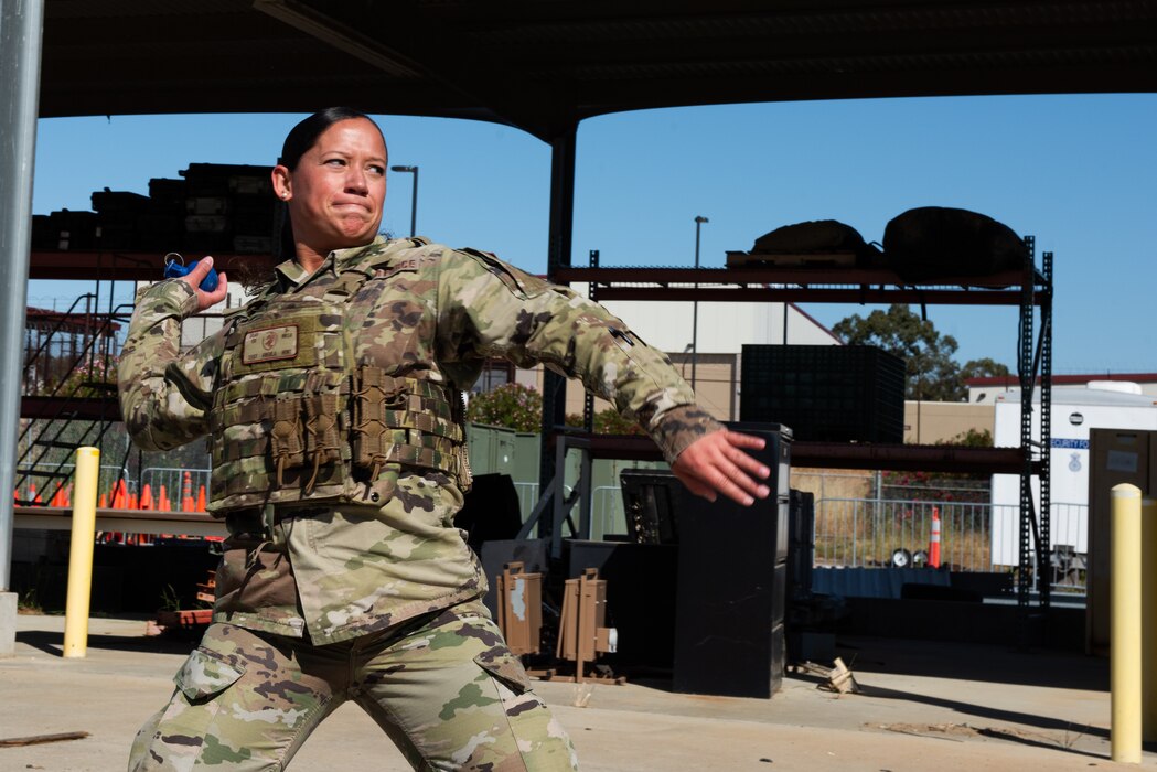 Airman throws a simulated grenade during a Warrior Challenge