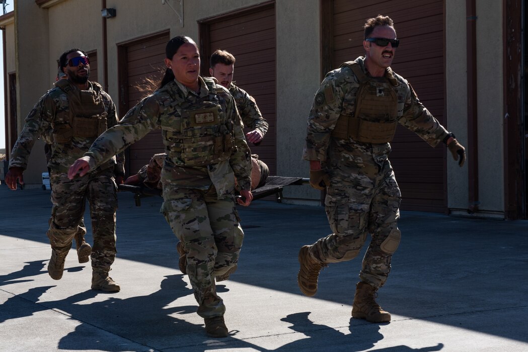 Airmen carry a simulated patient during a Warrior Challenge