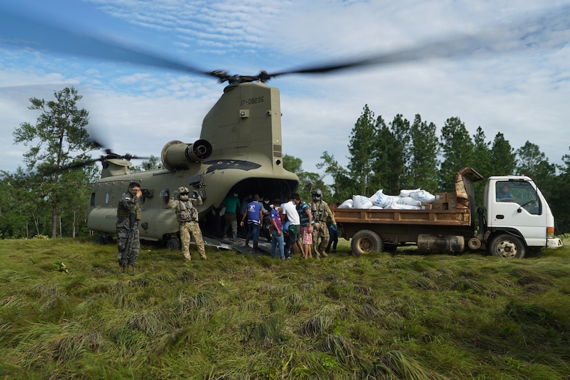 A photo of people unloading aid.