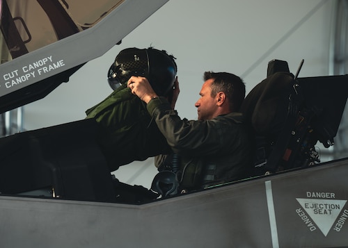 fighter pilot puts on helmet