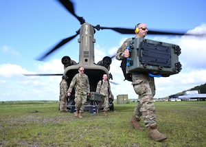 U.S. Air Force cyber operators and maintainers with the 103rd Air Control Squadron, Connecticut Air National Guard, unload a Tactical Operations System-Lite kit from a U.S. Army CH-47 Chinook assigned to Company B, 1st Battalion, 169th Aviation Regiment, Georgia Army National Guard, at Townsend Bombing Range, Georgia, May 15, 2024. As part of exercise Sentry Savannah, the 103rd ACS was the first National Guard unit to deploy and establish a cloud-based radar and radio connection from an austere, remote location using the TOC-L.