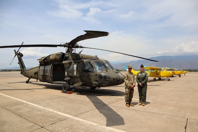 A photo of military members in front of aircraft.