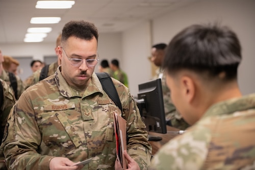 A photo of airmen processing documents