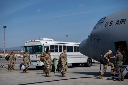 Airmen loading in from the front of a C-130J Super Hercules
