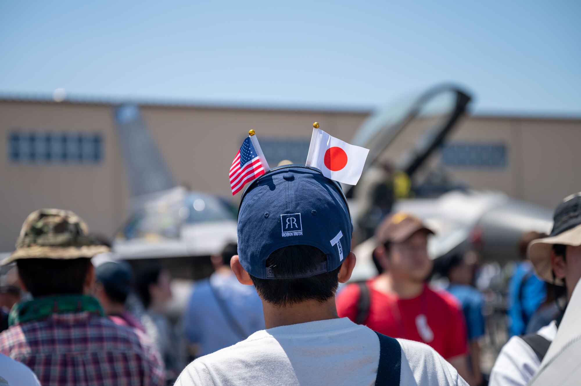Community members crowd near fighter aircraft static displays at the 2024 Japanese-American Friendship Festival at Yokota Air Base.
