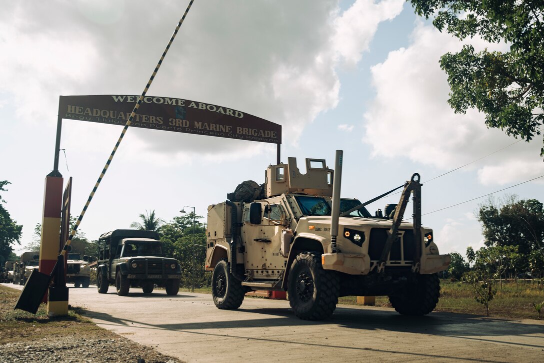 A U.S. Marine Corps Joint Light Tactical Vehicle departs Philippine Marine Base Camp Rodolfo with Philippine Marine Corps vehicles belonging to the 3rd Marine Brigade during a combined convoy and mobile defense exercise as part of Archipelagic Coastal Defense Continuum in Puerto Princesa, Palawan, Philippines, May 15, 2024. ACDC is a series of bilateral exchanges and training opportunities between U.S. Marines and Philippine Marines aimed at bolstering the Philippine Marine Corps' Coastal Defense strategy while supporting the modernization efforts of the Armed Forces of the Philippines. (U.S. Marine Corps photo by Cpl. Joseph Helms)