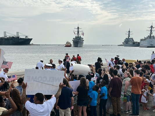 Families wait pierside as Arleigh-Burke class guided-missile destroyer USS Carney (DDG 64) returns home to Naval Station Mayport following a seven month deployment.