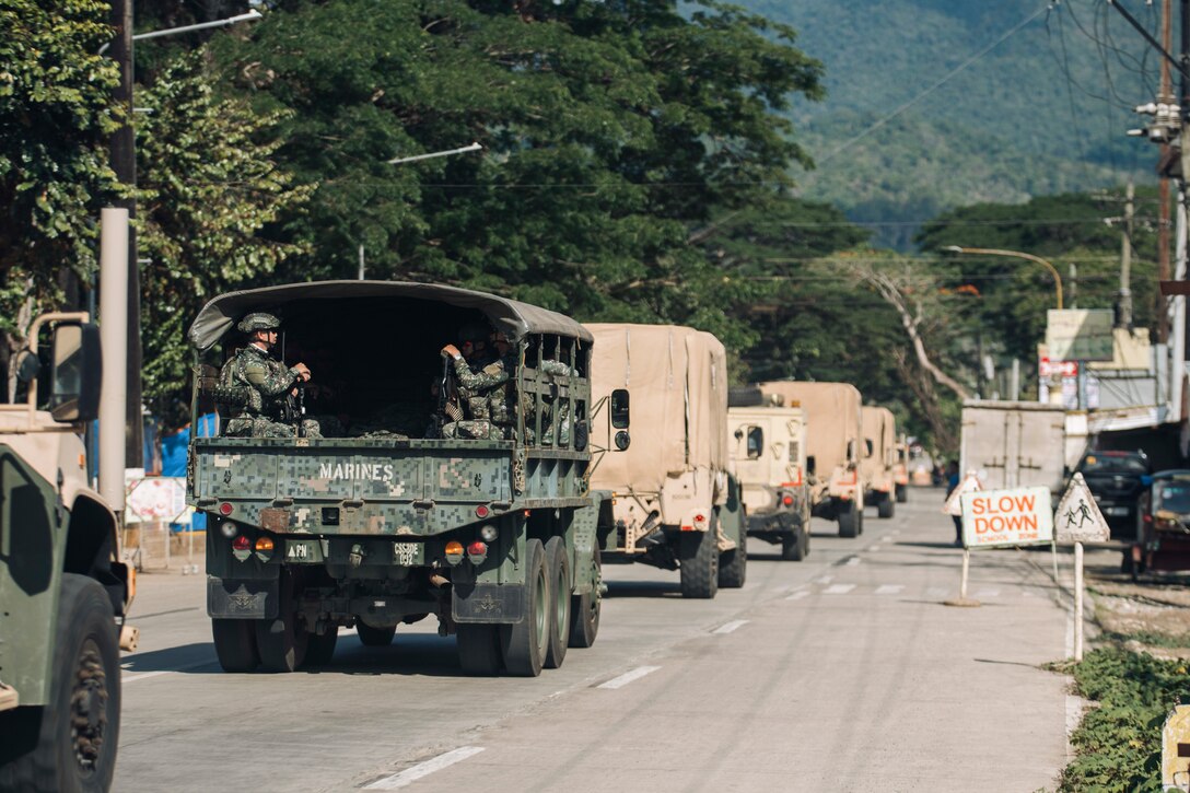 A Philippine Marine Corps KM250 truck attached to the 3rd Marine Brigade drives in a column with U.S. Marines assigned to the 15th Marine Expeditionary Unit through Palawan, Philippines, during a combined convoy and mobile defense exercise as part of Archipelagic Coastal Defense Continuum May 15, 2024. ACDC is a series of bilateral exchanges and training opportunities between U.S. Marines and Philippine Marines aimed at bolstering the Philippine Marine Corps' Coastal Defense strategy while supporting the modernization efforts of the Armed Forces of the Philippines. (U.S. Marine Corps photo by Cpl. Joseph Helms)