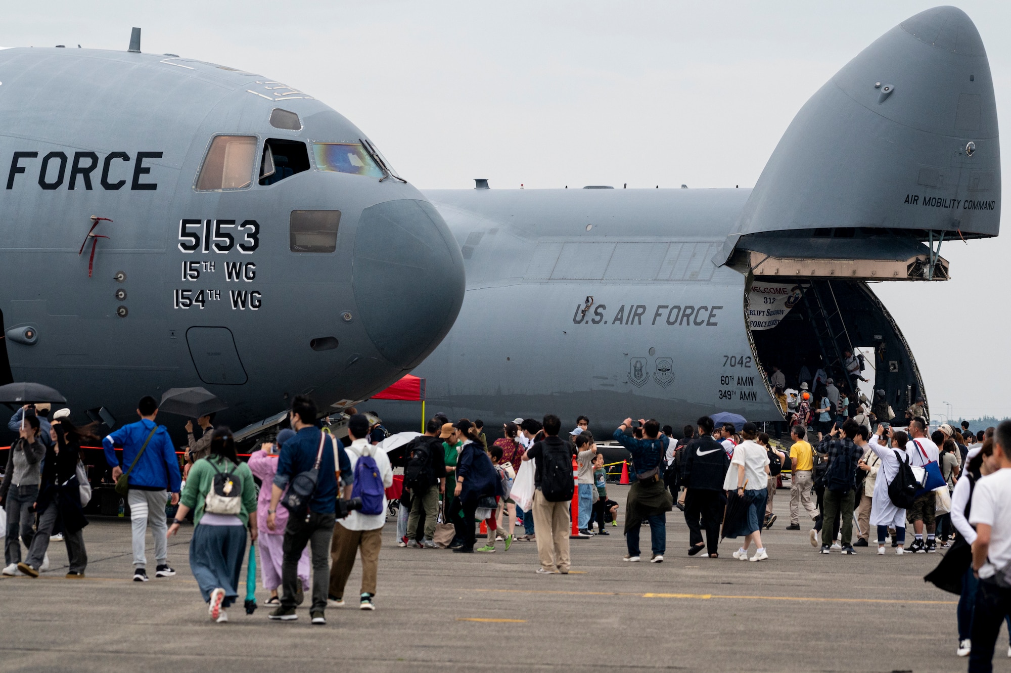 U.S. Air Force C-17 Globemaster III assigned to the 15th Wing, Joint Base Pearl Harbor-Hickam, and a C-5 Super Galaxy assigned to Travis Air Base, California, sit on display for attendees at the 2024 Japanese-American Friendship Festival at Yokota Air Base.