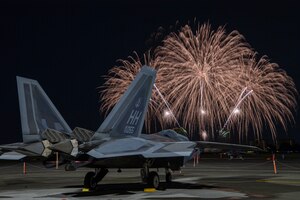 A U.S. Air Force F-22 Raptor assigned to the 199th Fighter Squadron sits on the flightline at Yokota Air Base, Japan, May 19, 2024 during the Japanese-American Friendship Festival fireworks display.