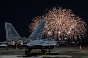 A U.S. Air Force F-22 Raptor assigned to the 199th Fighter Squadron sits on the flightline at Yokota Air Base, Japan, May 19, 2024 during the Japanese-American Friendship Festival fireworks display.