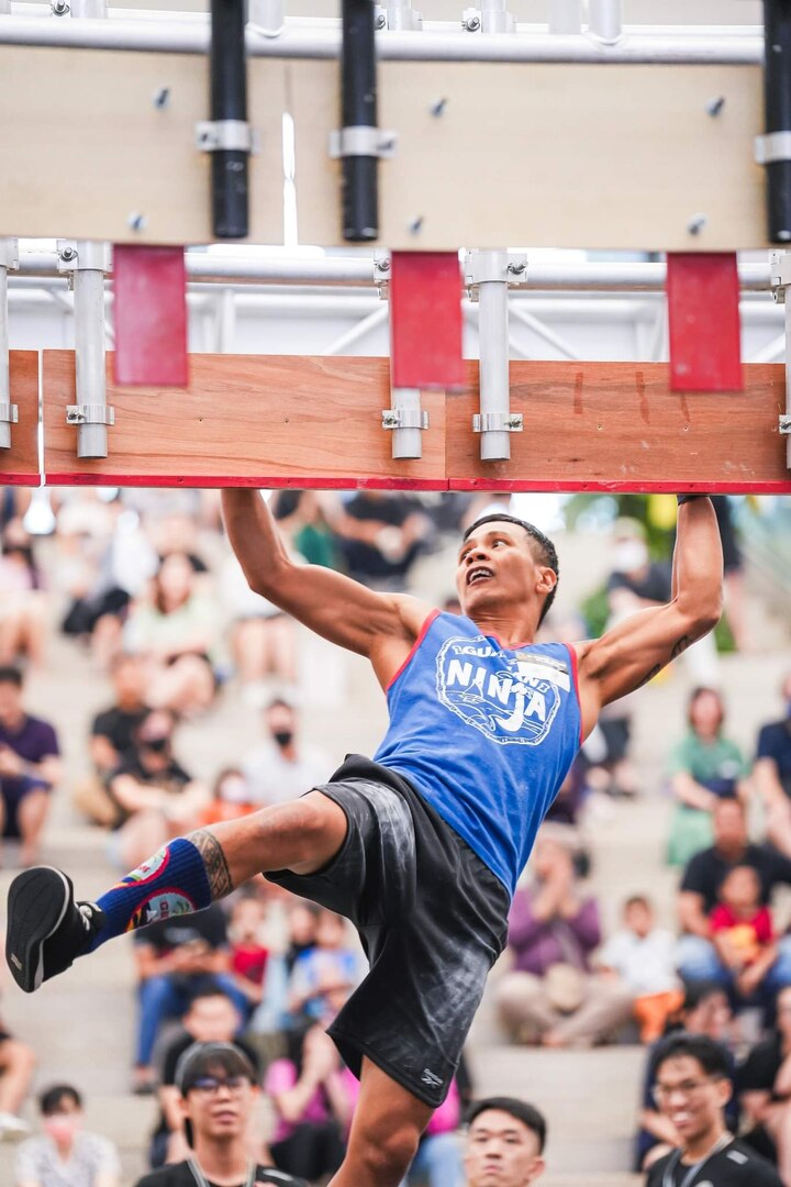 Chief Petty Officer Deren Perez, seen here competing in the Ninja Warrior games in 2023, was presented with the U.S. Coast Guard's Elite Male Athlete of the Year award by Capt. Nick Simmons, commander of U.S. Coast Guard Forces Micronesia Sector Guam, at the newly relocated recruiting office in Tamuning, Guam, on May 17, 2024. The award, presented on behalf of the U.S. Coast Guard MWR and the Community Services Command, is a testament to his exceptional athletic abilities and his unwavering dedication to his community. (Photo courtesy Chief Petty Officer Deren Perez)