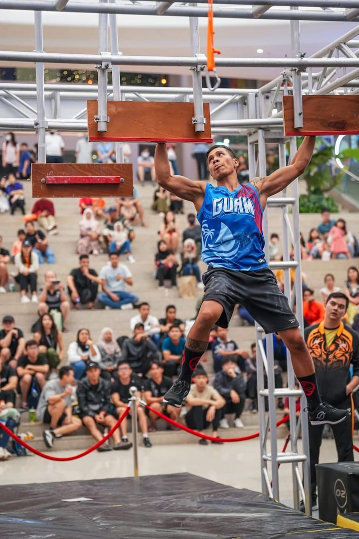 Chief Petty Officer Deren Perez, seen here competing in the Ninja Warrior games in 2023, was presented with the U.S. Coast Guard's Elite Male Athlete of the Year award by Capt. Nick Simmons, commander of U.S. Coast Guard Forces Micronesia Sector Guam, at the newly relocated recruiting office in Tamuning, Guam, on May 17, 2024. The award, presented on behalf of the U.S. Coast Guard MWR and the Community Services Command, is a testament to his exceptional athletic abilities and his unwavering dedication to his community. (Photo courtesy Chief Petty Officer Deren Perez)