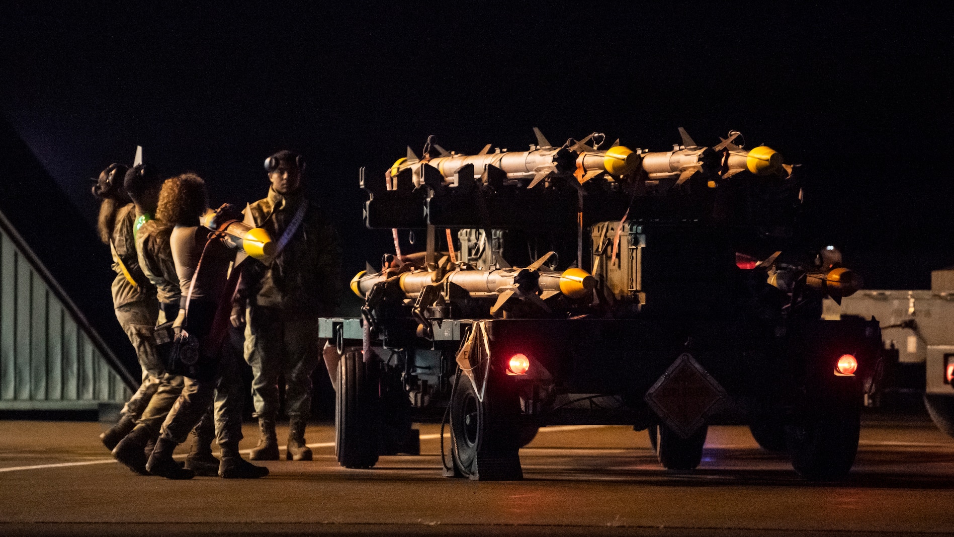 A U.S. Air Force 14th Fighter Generation Squadron weapons load crew team carries a live AIM-9 Sidewinder missile back to a munitions trailer after conducting an F-16 Fighting Falcon weapons load during a  Combat Ammunition Production Exercise (CAPEX) at Misawa Air Base, Japan, May 6, 2024.