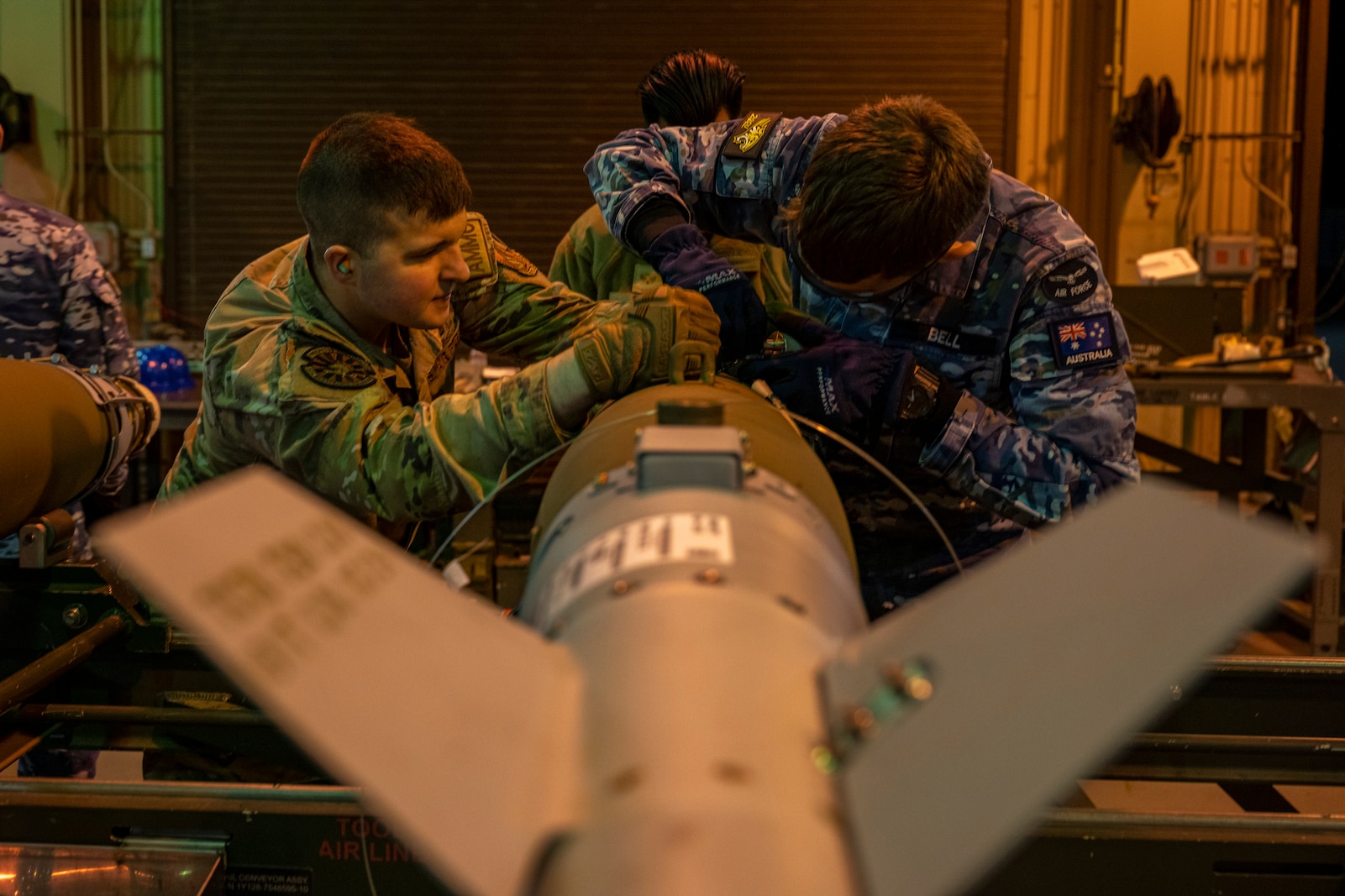 U.S. Air Force and Royal Australian Air Force members construct munitions together during a Combat Ammunition Production Exercise (CAPEX) at Misawa Air Base, Japan, May 8, 2024.