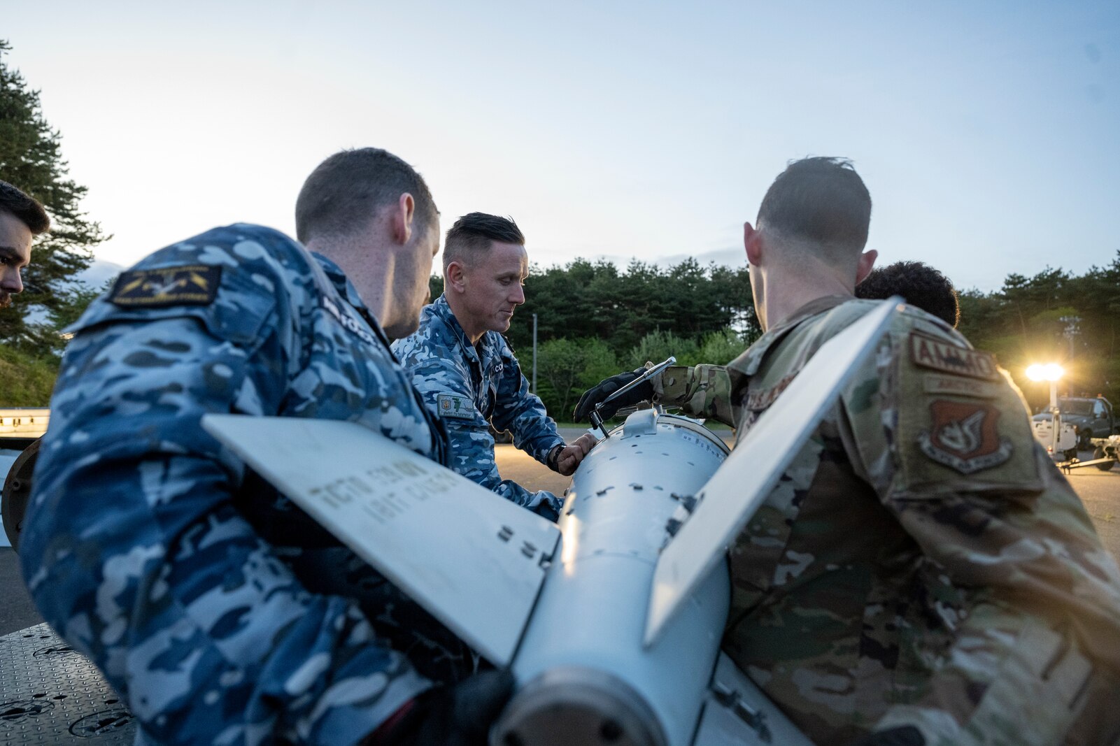 U.S. Air Force and Royal Australian Air Force members construct munitions together during a Combat Ammunition Production Exercise (CAPEX) at Misawa Air Base, Japan, May 8, 2024.