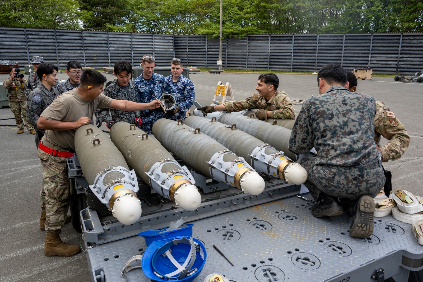 U.S. Air Force, Royal Australian Air Force, and Japan Air Self-Defense Force members construct munitions together during a Combat Ammunition Production Exercise (CAPEX) at Misawa Air Base, Japan, May 8, 2024.