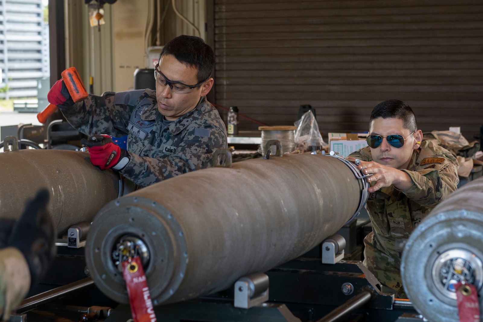 U.S. Air Force and Japan Air Self-Defense Force members work side by side to build munitions during Combat Ammunition Production Exercise at Misawa Air Base, Japan, May 8, 2024.