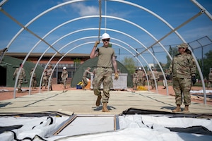 U.S. Airmen build tents during the base exercise Aw-R-Go at Royal Air Force Mildenhall, England, May 8, 2024.