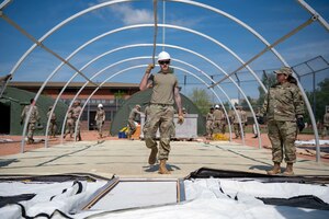 U.S. Airmen build tents during the base exercise Aw-R-Go at Royal Air Force Mildenhall, England, May 8, 2024.