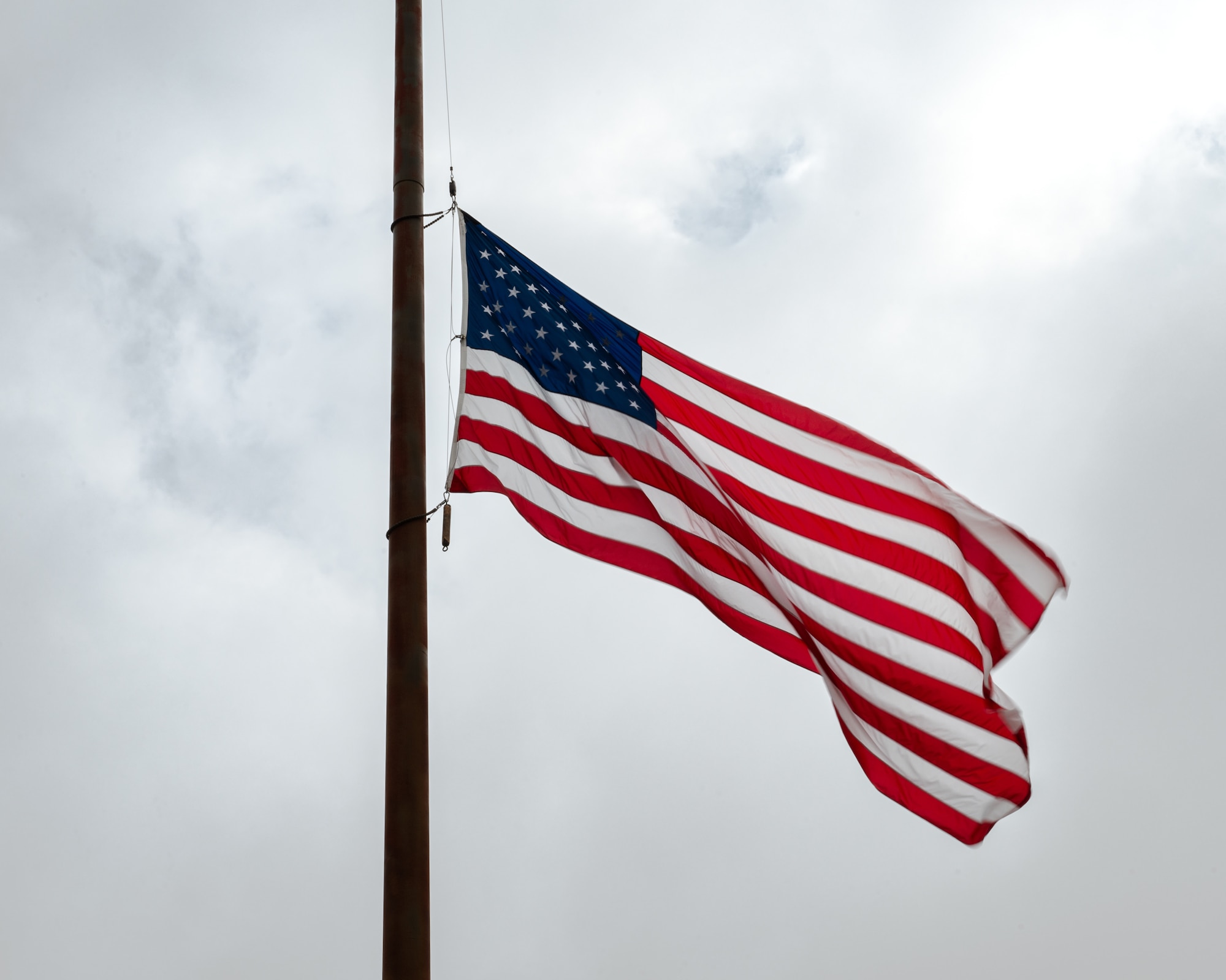 The U.S. flag hangs at half-staff during the opening ceremony of National Police Week at Dyess Air Force Base, Texas, May 13, 2024. Flags were lowered to half-staff in solemn observance of National Police Week, which recognized the men and women who had sworn an oath to protect and serve, and who had made the ultimate sacrifice. (U.S. Air Force photo by Airman 1st Class Jade M. Caldwell)