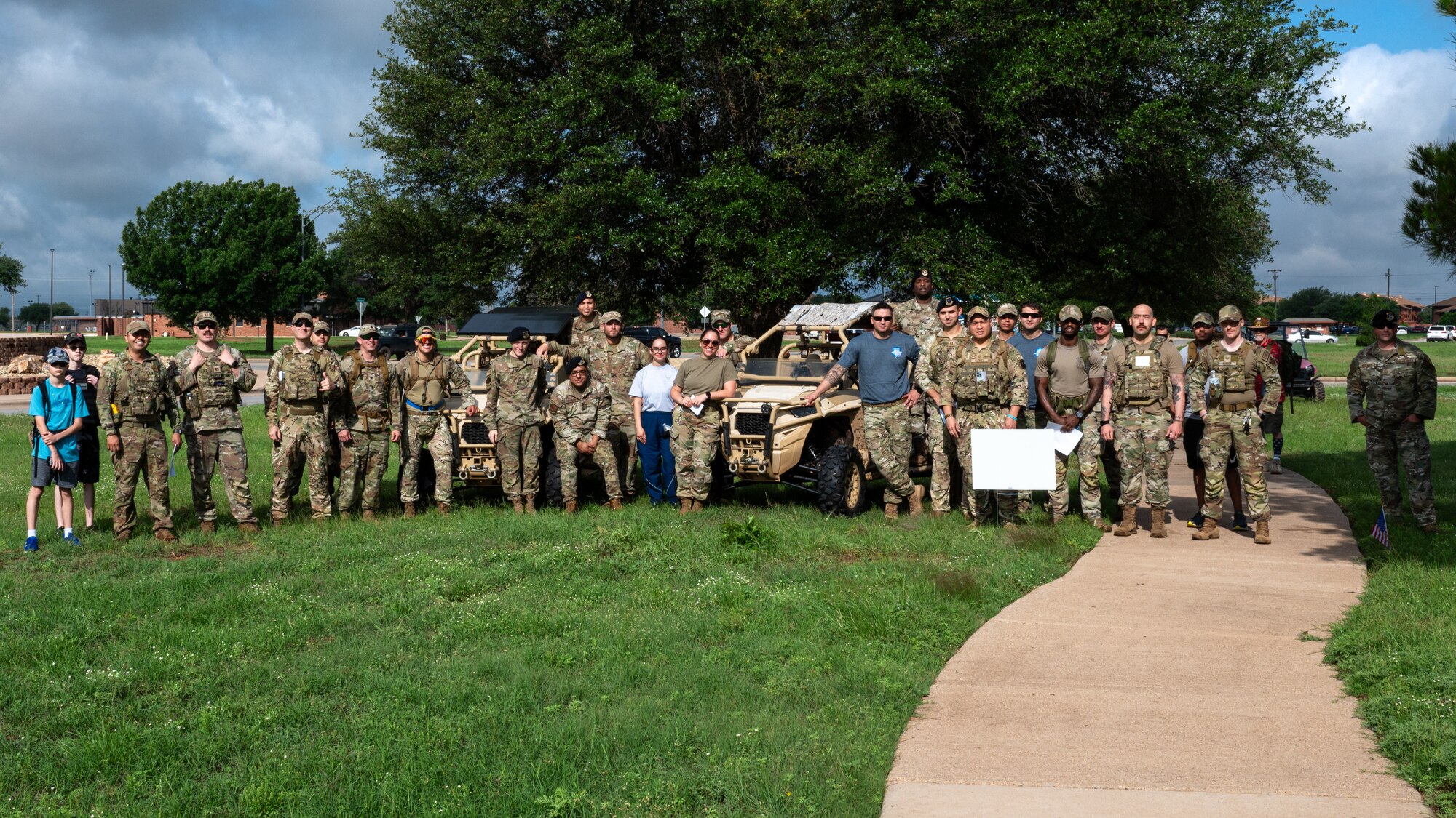 Members from team Dyess gather for a group photo during National Police Week at Dyess Air Force Base, Texas, May 13, 2024. The week-long commemoration of Police Week at Dyess allowed law enforcement, survivors, families of fallen officers, and community members to come together, honoring those who made the ultimate sacrifice and to express gratitude for those who protect our communities. (U.S. Air Force photo by Airman 1st Class Jade M. Caldwell)