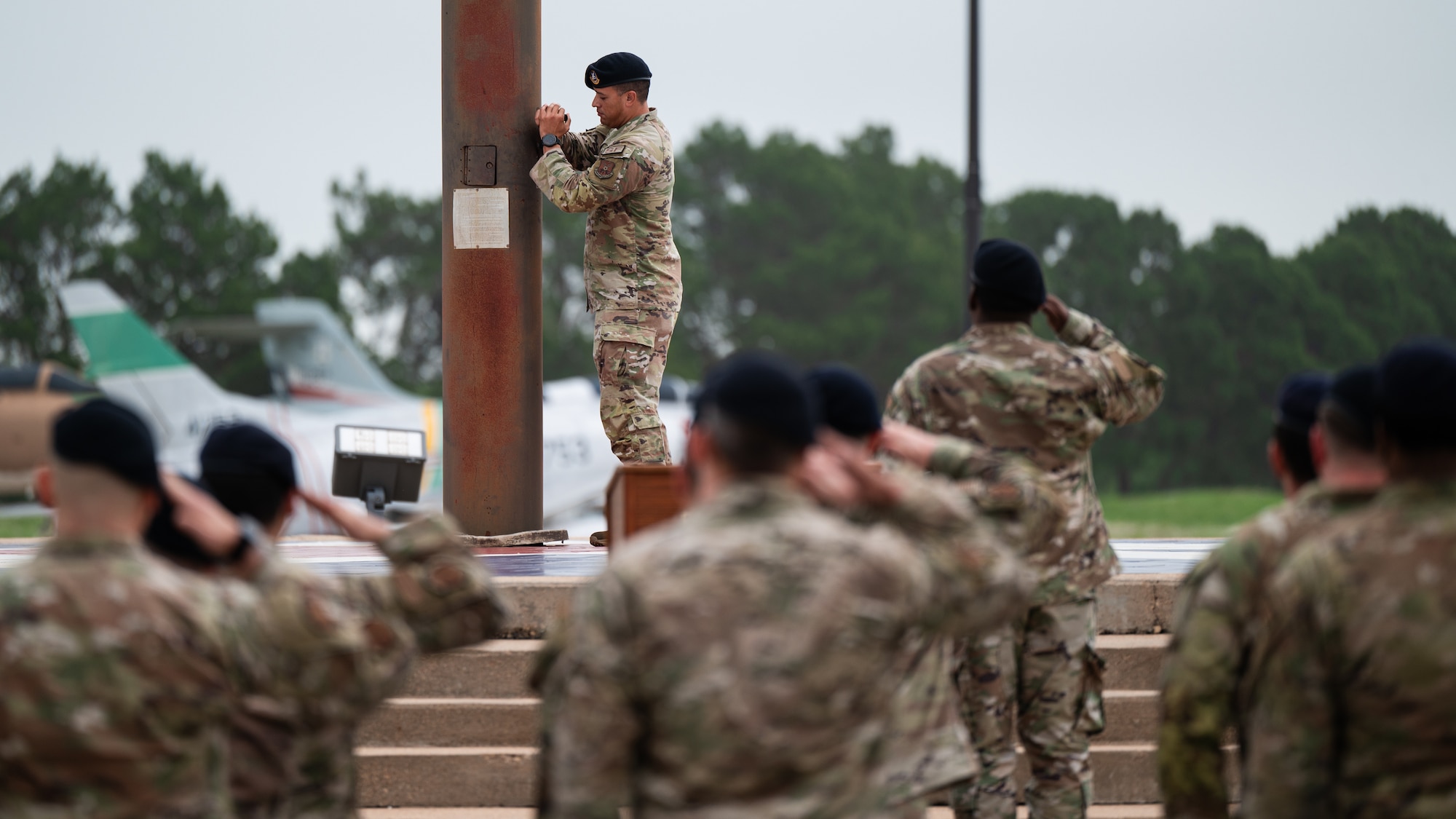 U.S. Air Force Airmen from the 7th Security Forces Squadron salute in formation as the U.S. flag is lowered to half-staff during the opening ceremony for National Police Week at Dyess Air Force Base, Texas, May 13, 2024. In 1962, former President John F. Kennedy declared May 15 as Peace Officers Memorial Day and the week surrounding it as Police Week. (U.S. Air Force photo by Airman 1st Class Jade M. Caldwell)