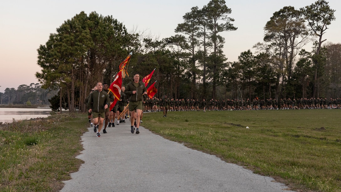 U.S. Marines with Headquarters Battalion, 2d Marine Division run in formation during a motivation run on Camp Lejeune, North Carolina, March 21, 2024. The motivational run was three miles and used to build cohesion and promote fitness. (U.S. Marine Corps photo by Lance Cpl. Oliver Nisbet)