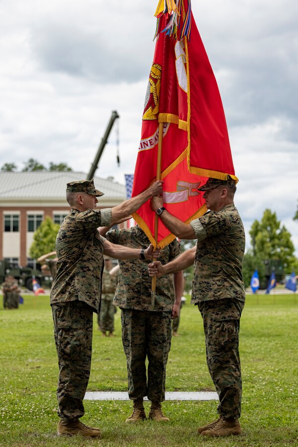 U.S. Marine Corps Maj. Gen. Scott F. Benedict, right, from California, and former commanding general of the 2nd Marine Aircraft Wing (MAW) passes the organizational colors to Maj. Gen. William H. Swan, from Wisconsin and commanding general of 2nd MAW during a change of command ceremony at Marine Corps Air Station Cherry Point, North Carolina, May 16, 2024. The ceremony represented a transfer of responsibility, authority, and accountability from Benedict to Swan. (U.S. Marine Corps photo by Lance Cpl. Orlanys Diaz Figueroa)
