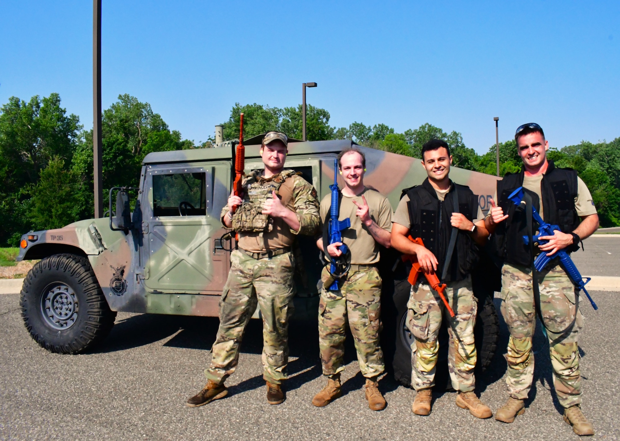airmen posing in front of Humvee