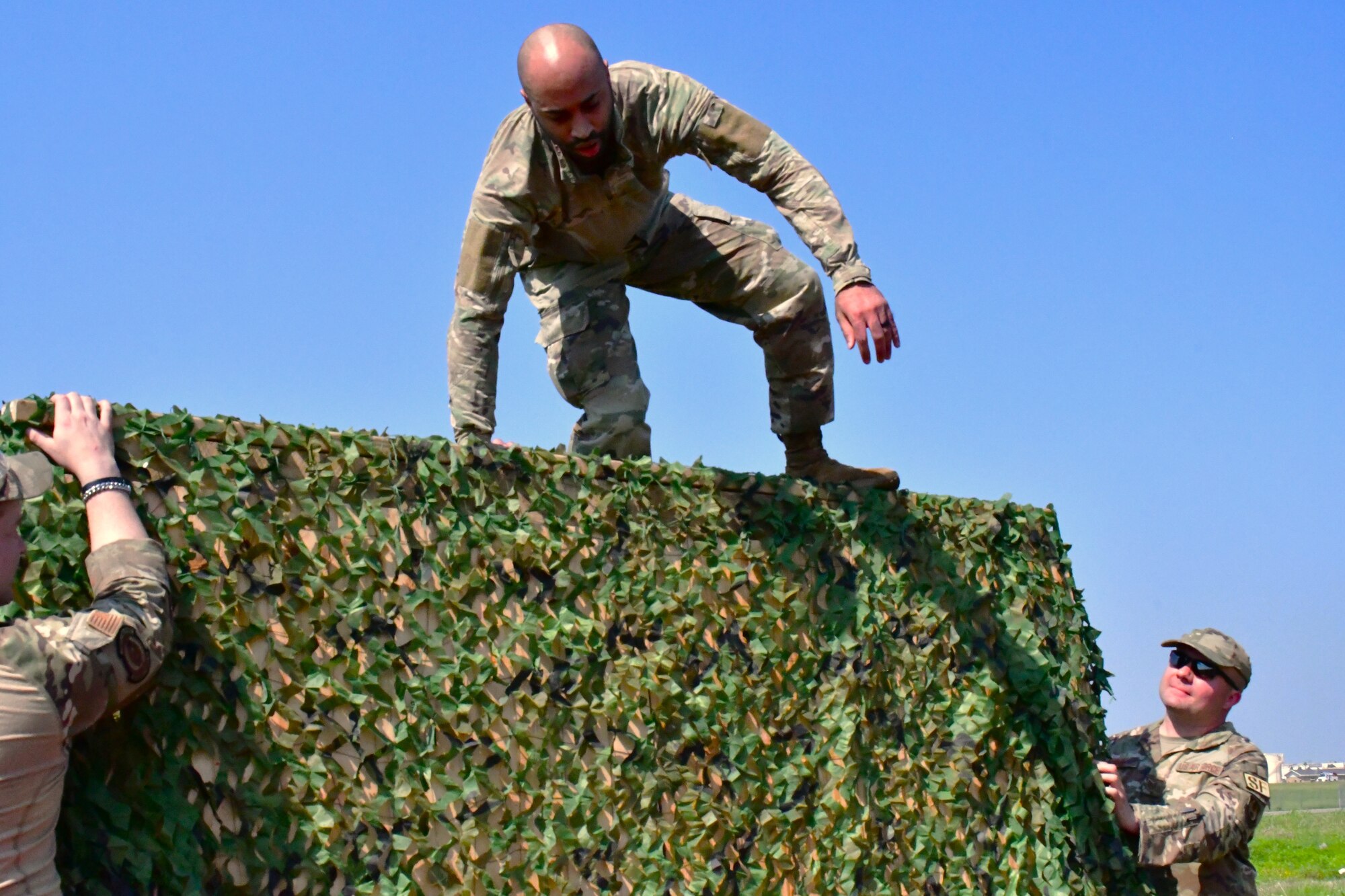 man jumping over obstacle