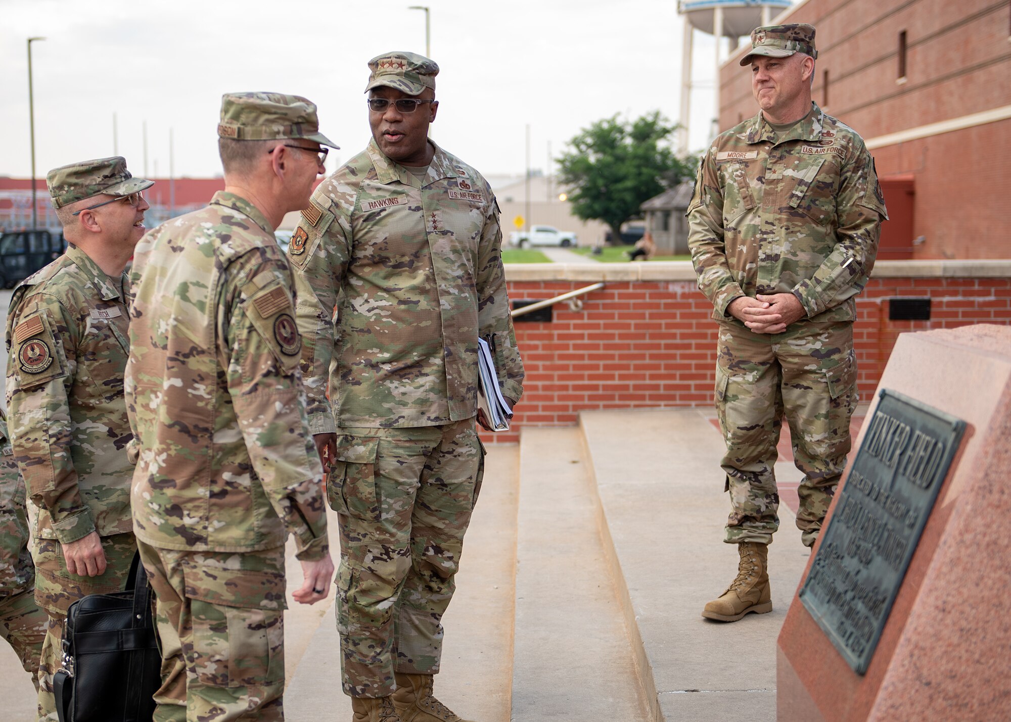 Group of four men meeting on stairs outside building