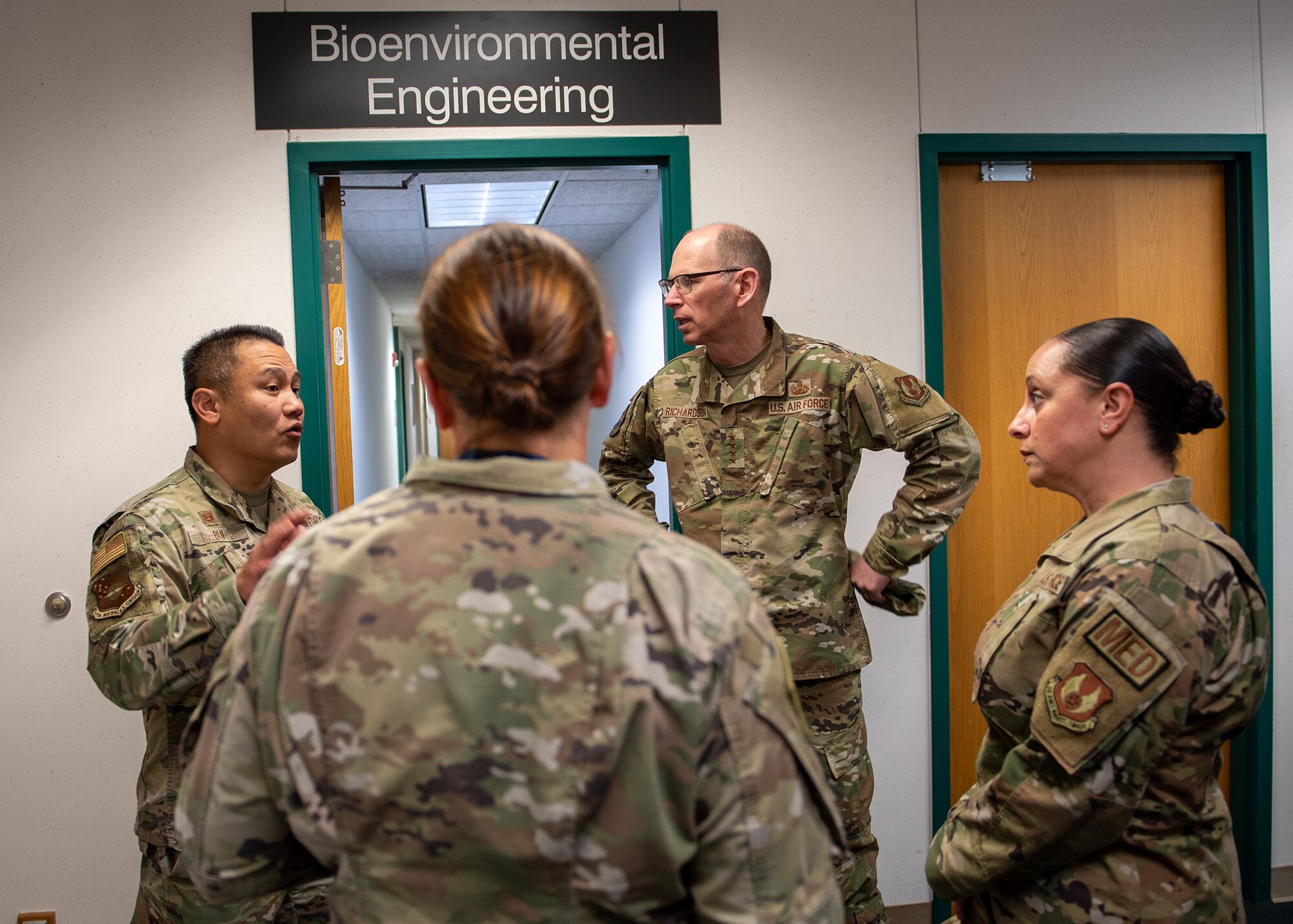 Group of men and women talking in hallway