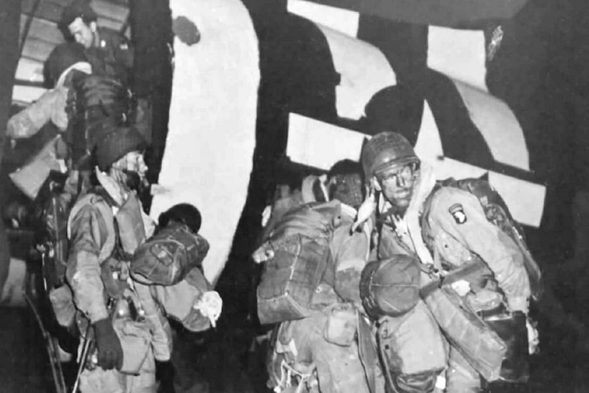 Soldiers board an aircraft.