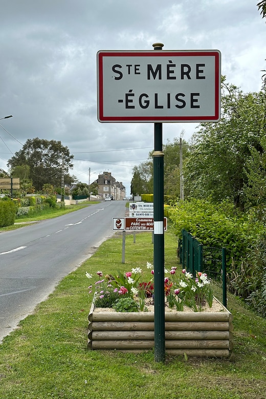 A sign marks the entrance to a town.