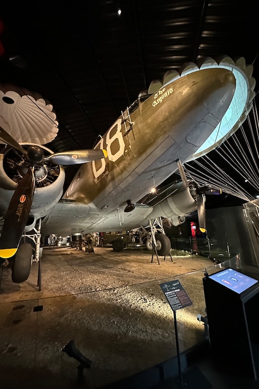 A large aircraft is on display in a museum.